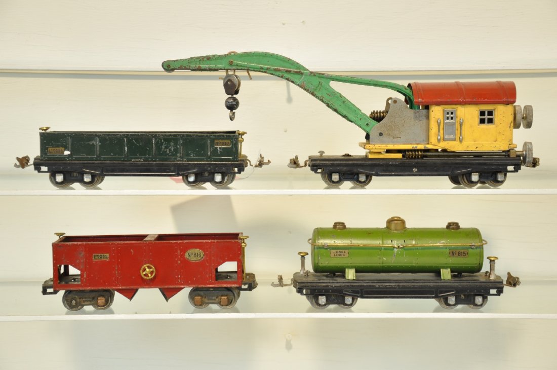 4 Lionel 800 Series Cars: Includes an 810 derrick, 1st late color variation, functional, needs stringing; 816 hopper, no couplers; 815 tank car; 812 gondola. All show moderate to heavy playwear, C4