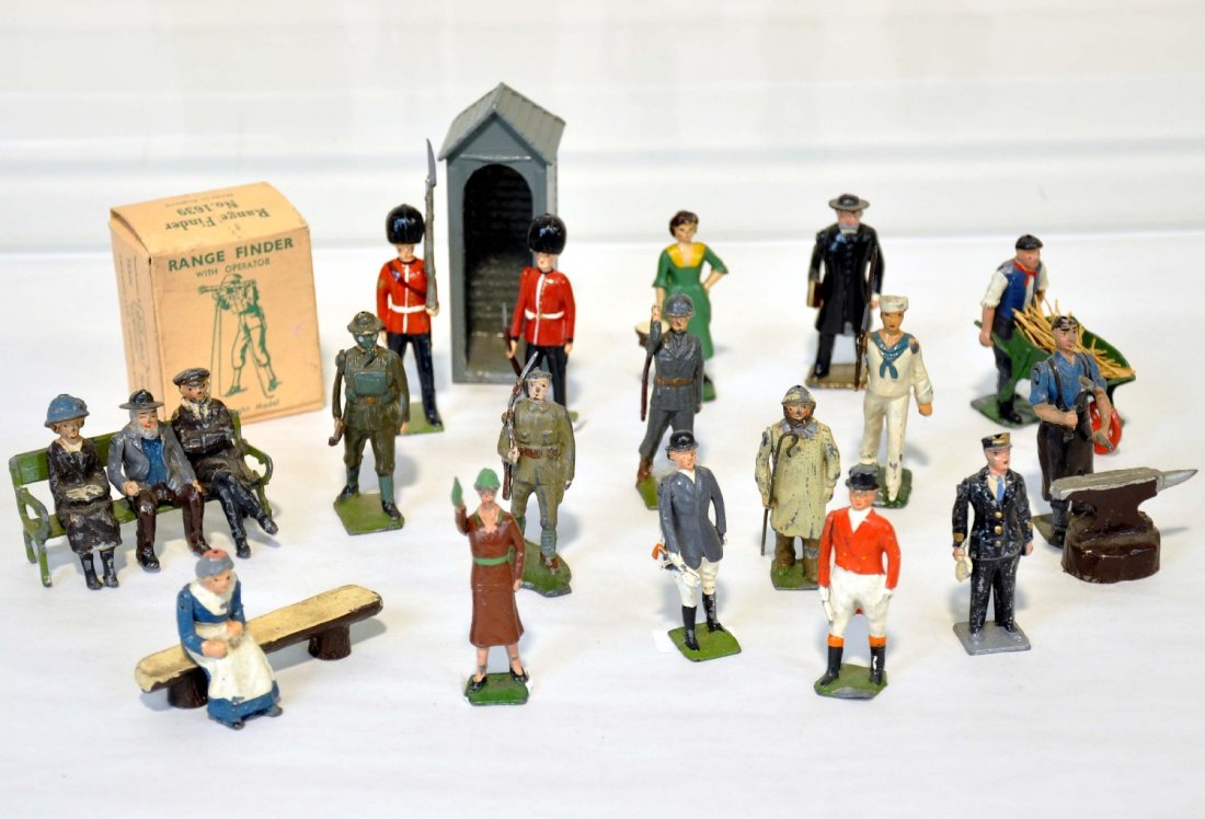 25 Britains Soldiers & Civilians: Includes a Mint boxed 1639 range finder; 2 Cold Stream Guards with guard shack; and assorted others with a circus horse trainer, blacksmith & others. Most show light playwear. Grade range is C6-9, so 