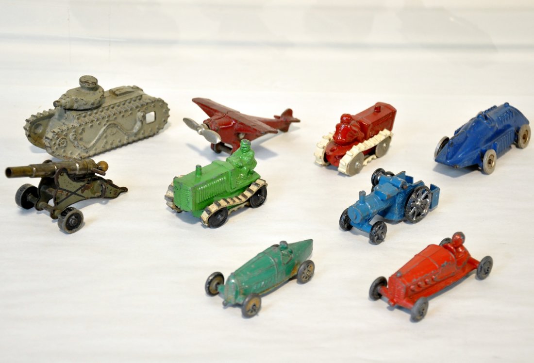 Cast Iron & Slush Vehicle Lot: Cast iron includes a 4 1/2" tank; mono plane; record racer; tractor; steam tractor; Slush tractor, treads dry; 33 racer; boat tail racer. Plus a German cannon, probably Marklin. All show light to mode