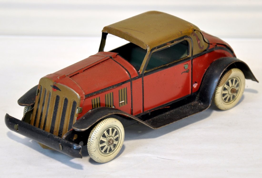 Marx Litho Tin Coupe: Circa 1935. 8" tin coupe, mechanism functions. It was also offered with the Deluxe gas station set. It shows light playwear, C7-7+