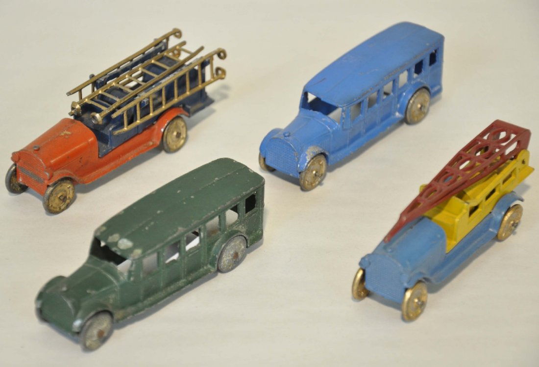 4 Early TootsieToy Vehicles: Includes a fire ladder truck; fire water tower; 2 Fagiole busses. All show light to moderate playwear, C6-7
