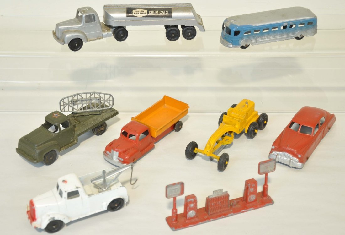 8 TootsieToy Jumbo Pieces: Includes a Union Carbide tanker; tow truck; military radar truck; road grader; gas pumps; Greyhound bus & dump truck. All show light to moderate playwear, C6-7+