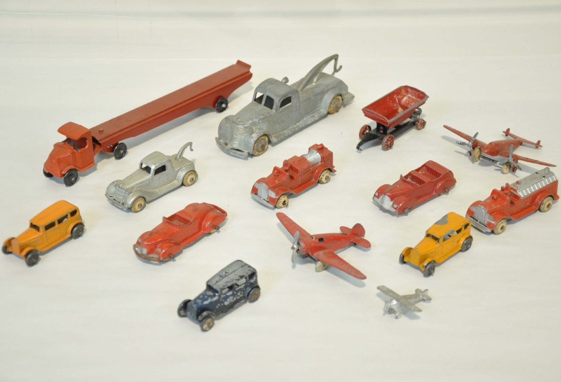11 Assorted TootsieToy Vehicles: Includes 3" fire ladder; fire pumper; 2 convertibles; tow truck; 2 mono planes, game piece plane; construction trailer; 5" tow truck; 7 1/2" Mack auto-loader with repro trailer & 3 sedans. Grade range