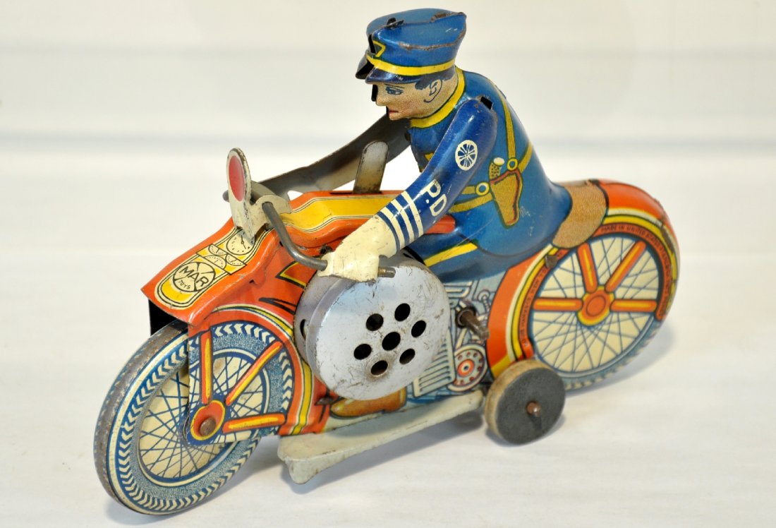 Marx Police Motorcycle with Siren: Litho tin, 8" long. Mechanism functions with realistic sounding siren. It is clean & shiny, showing light to moderate playwear, C6+-7