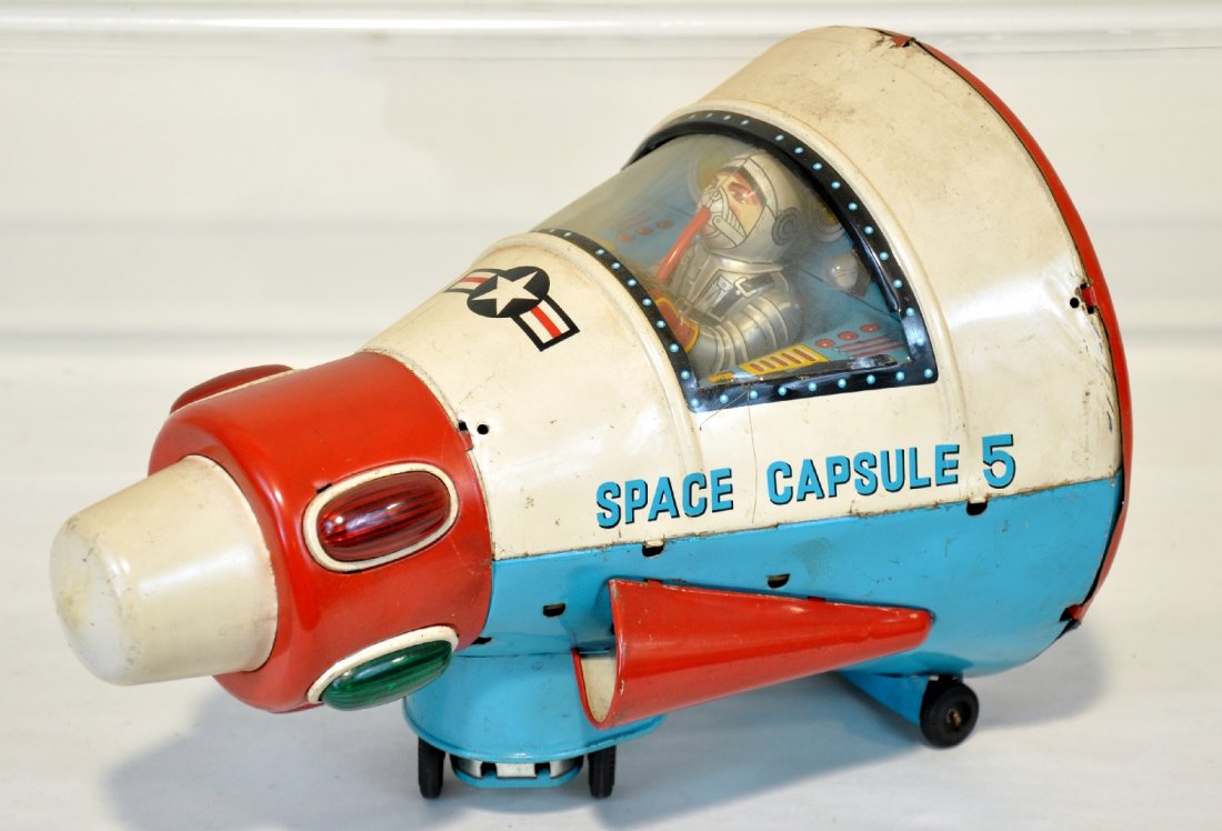Early Modern Toy Space Capsule 5: Nice battery operated toy. Earlier version of The Apollo Capsule. Litho tin, 10" long with functional mechanism. Has blinking lights, animated spaceman and mystery action. The battery box is clean, bu