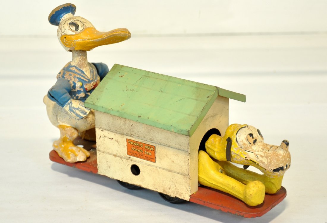 Lionel Disney 1107 Donald & Pluto Handcar: Circa 1935. All original with composition Donald Duck & Pluto Figures. Pluto is missing 1/2 of an ear and overall paint is 60%. The mechanism doesn't function, but makes a nice display anyway, C4