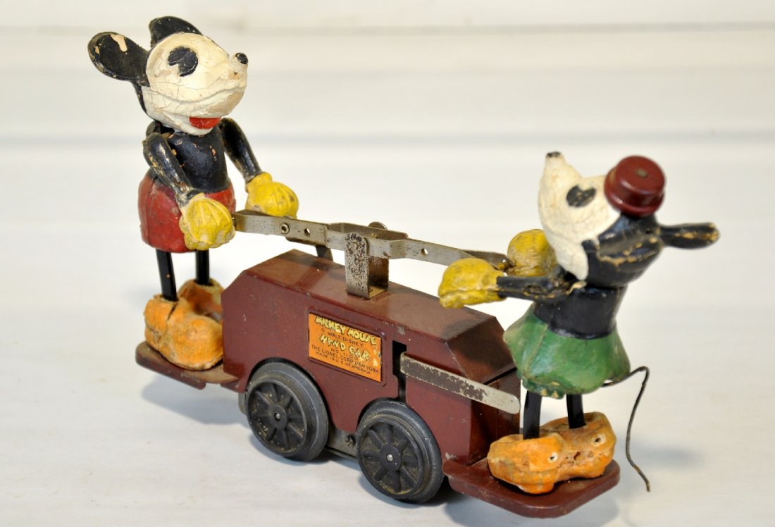 Rare Lionel Maroon 1100 Mickey Handcar: Toughest of all the versions with maroon car. The composition Mickey & Minnie Mouse figures are intact with original tails, but replaced legs. The mechanism holdback slips, so AS-IS operation. It coul