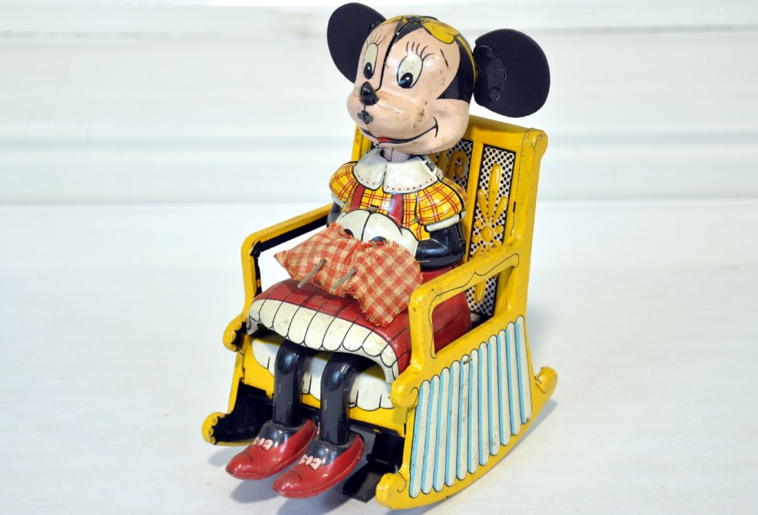 Marx Knitting Minnie Mouse: Clean litho tin toy. 7" tall with original ears. Mechanism is functional and has nice bright color. It shows light playwear, C7+-8