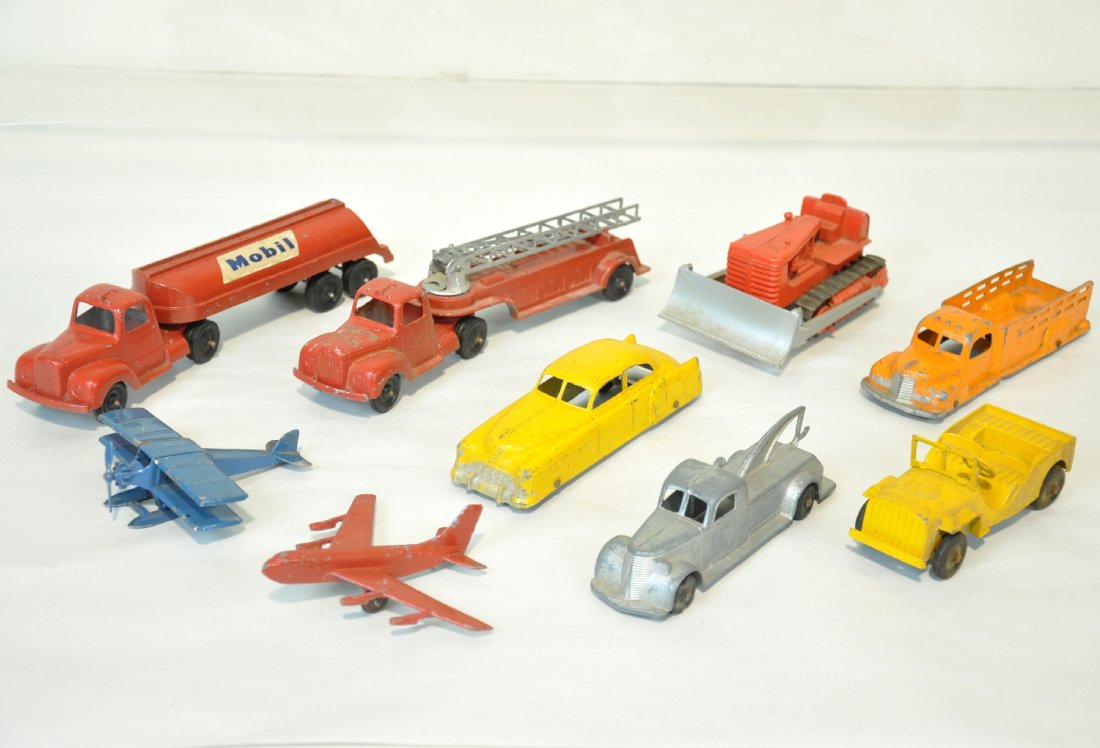 9Pc TootsieToy Vehicle Lot: Includes an early 4675 sea plane, C5; Jumbos include early wrecker; stake truck, bent railing; Fire ladder truck; Mobilgas tanker; bulldozer (Hubley); Cadillac sedan; yellow jeep; Jet. Grade range is 