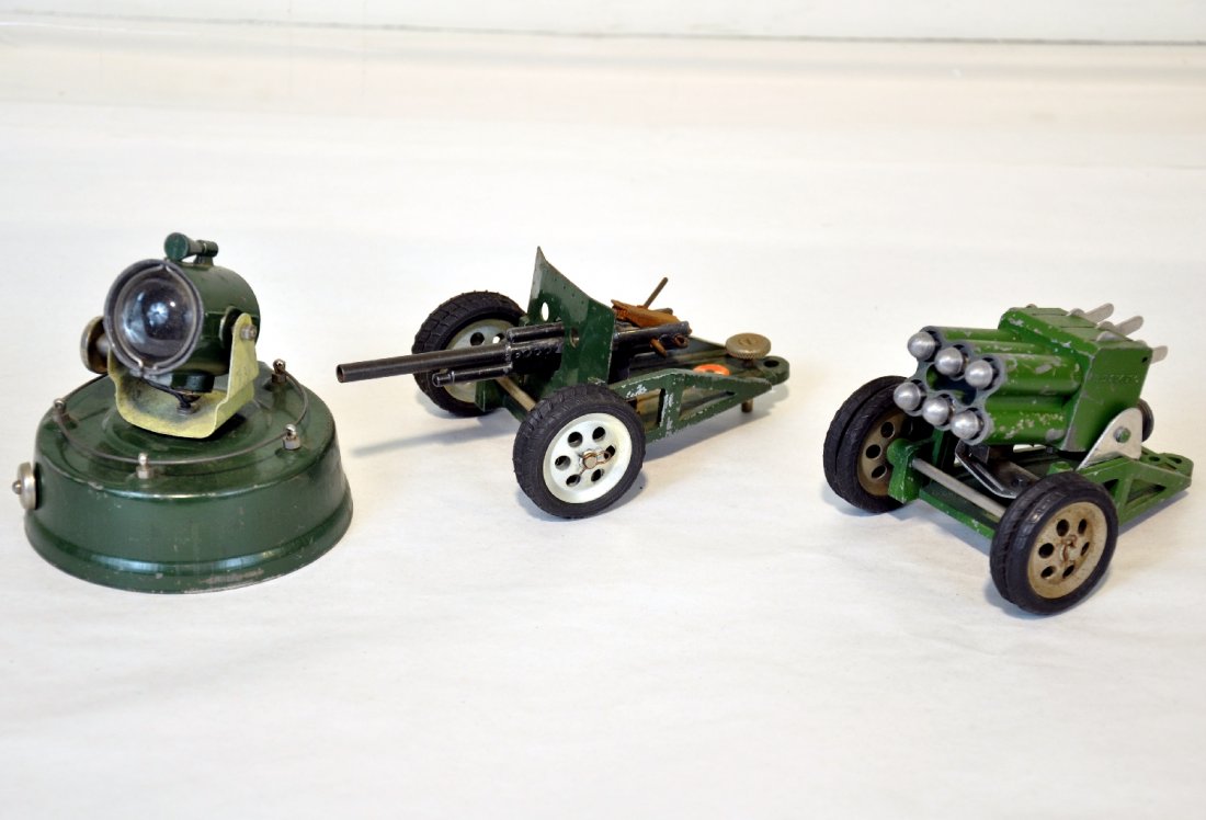 3 Astra Military Toys: Includes a tin searchlight; Howitzer, both show light wear, C8; Rocket launcher with 6 rockets, mechanism functions, C5+