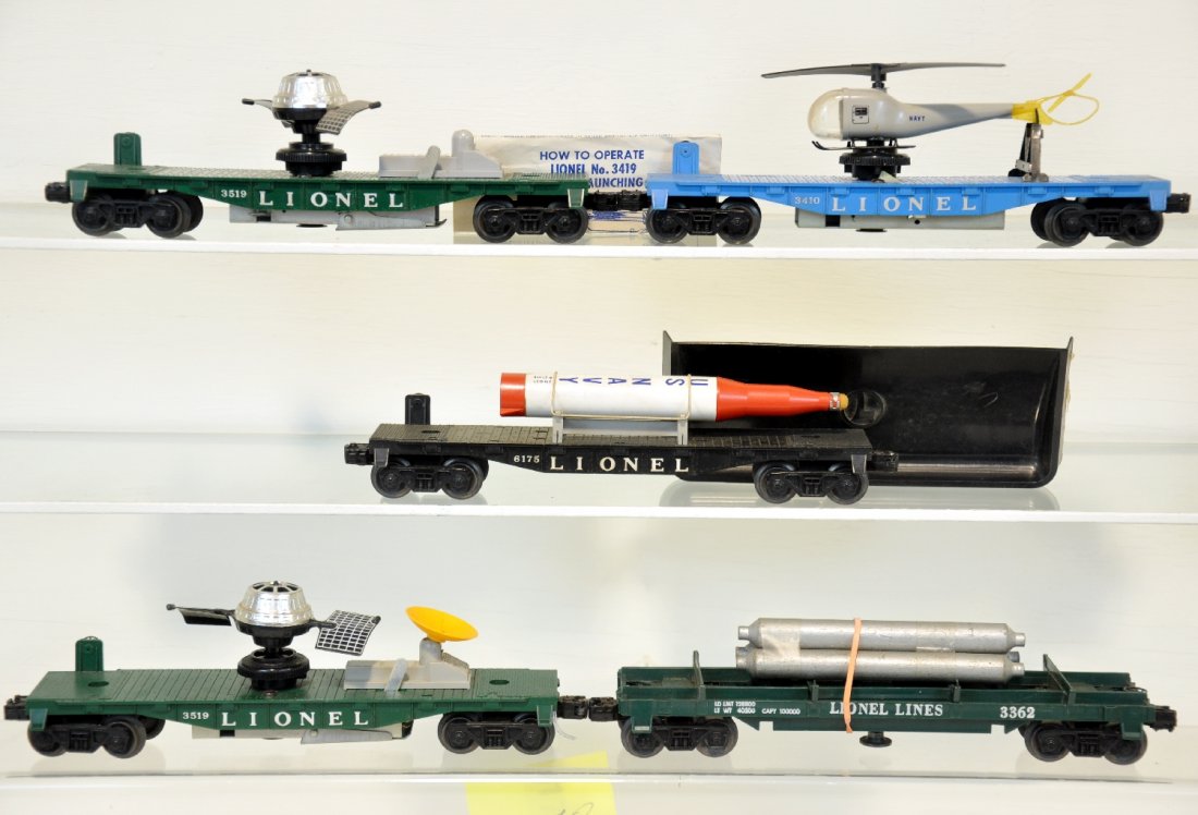 5 Lionel Late Freight Cars: Includes a 3410 manual helicopter car with original intact copter; 2 #3519 satellite launchers, 1 missing dish; 6175 flat with rocket; 3362 helium tank unloader with bin. All could use a cleaning, but
