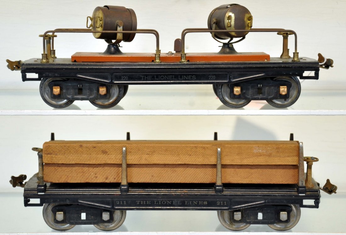 Lionel 211 & 220 Freight Cars: Standard Gauge. Includes a 220 searchlight car, tarnished brass; 212 lumber car with old, but not original load. They show light to moderate playwear, otherwise C7