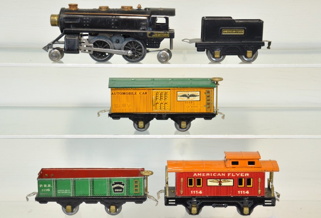 5Pc Early Champion Freight Set: O Gauge. Circa 1933. Includes a 614 tin steam loco with tender; 1116 PRR sand car; 1115 boxcar; 1114 caboose. All are clean & shiny, showing light to moderate playwear, C6+-7