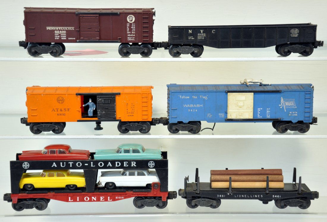 6 Lionel Freight Cars: Includes a 6454 PRR boxcar; 6462 NYC gondola; 6414 auto-loader, 3 cars have broken bumpers; 3424 brakeman car, car only; 3464 SF operating boxcar; 3461 lumber dump car with bin. Otherwise all show lig