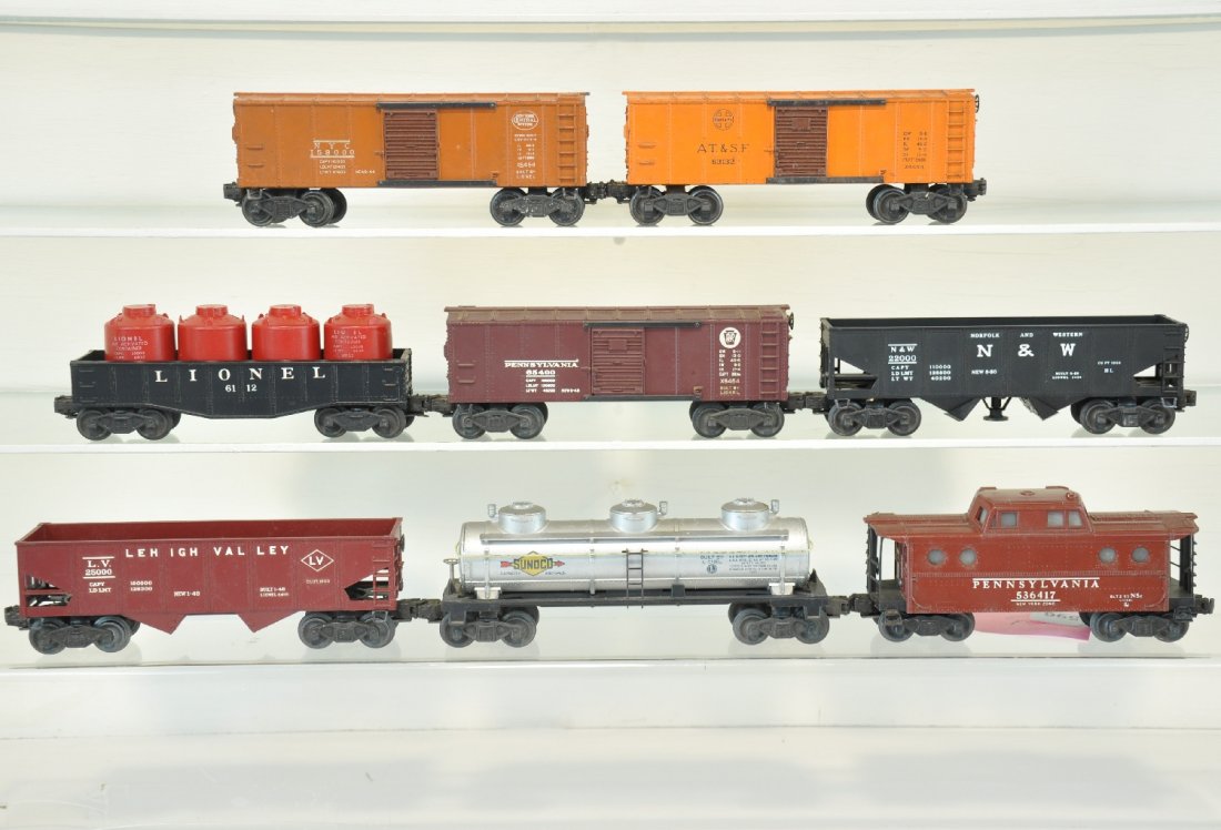 8 Lionel Freight Cars: Includes scarce 6454 SF & NYC early colored boxcars, dirty, C6; 6112 gondola with canisters; 3456 N&W operating hopper; 6454 PRR boxcar; 6417 PRR N5c caboose; 6415 Sunoco tank car; 6457 LV hopper. Oth