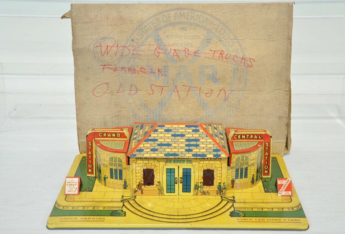 Boxed Marx Grand Central Station: Clean, litho tin illuminated station, 16 1/2" with original island glass window inserts. It shows light playwear with clean, but worn box, C7+