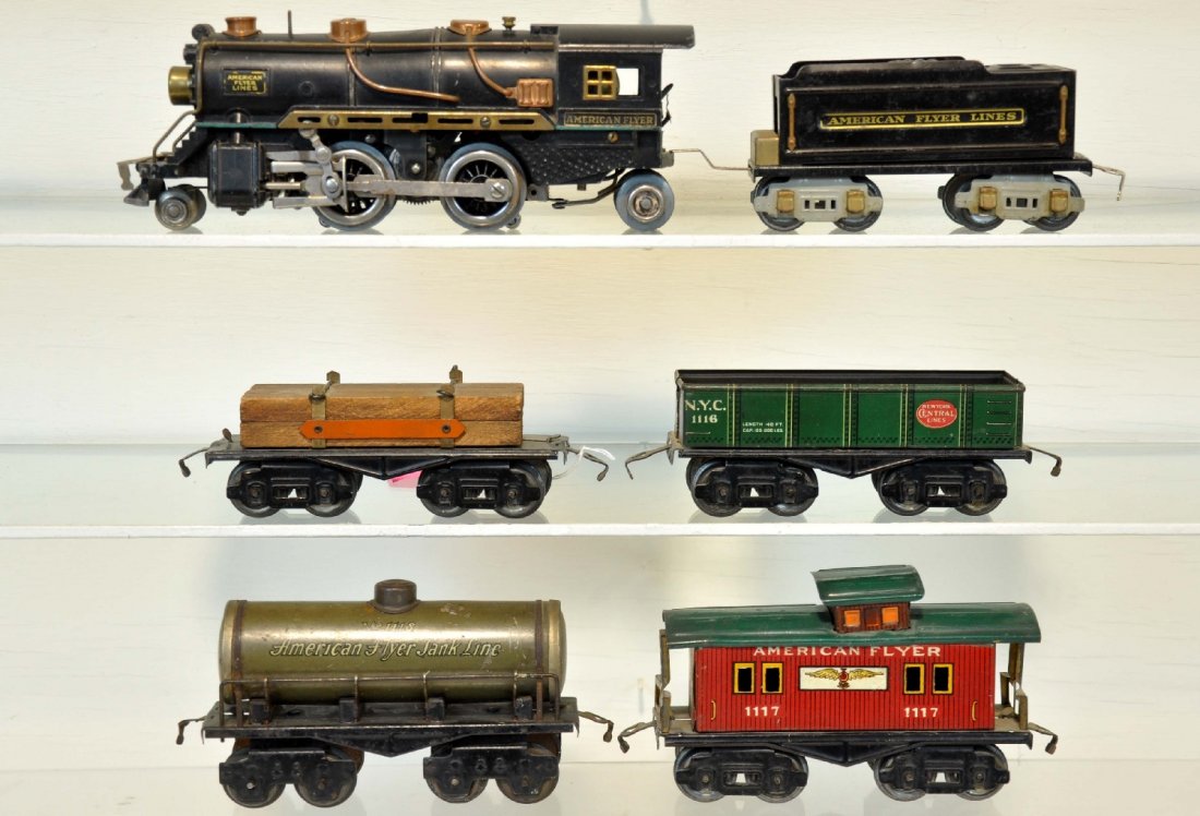 6Pc American Flyer Steam Freight Set: O Gauge. Includes a 3307 loco with bell; 3189 tender; 3046 lumber car; 1116 sand car; 1118 tank car; 1117 caboose. All show moderate playwear, C6-6+