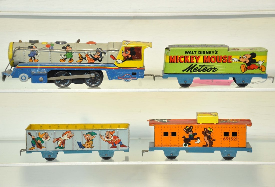 Clean Marx Mickey Mouse Meteor: Includes a litho tin steam loco, mechanism is functional with key; Meteor tender; gondola & caboose. All show wonderful graphics with Disney characters, clean showing light to moderate playwear, C7