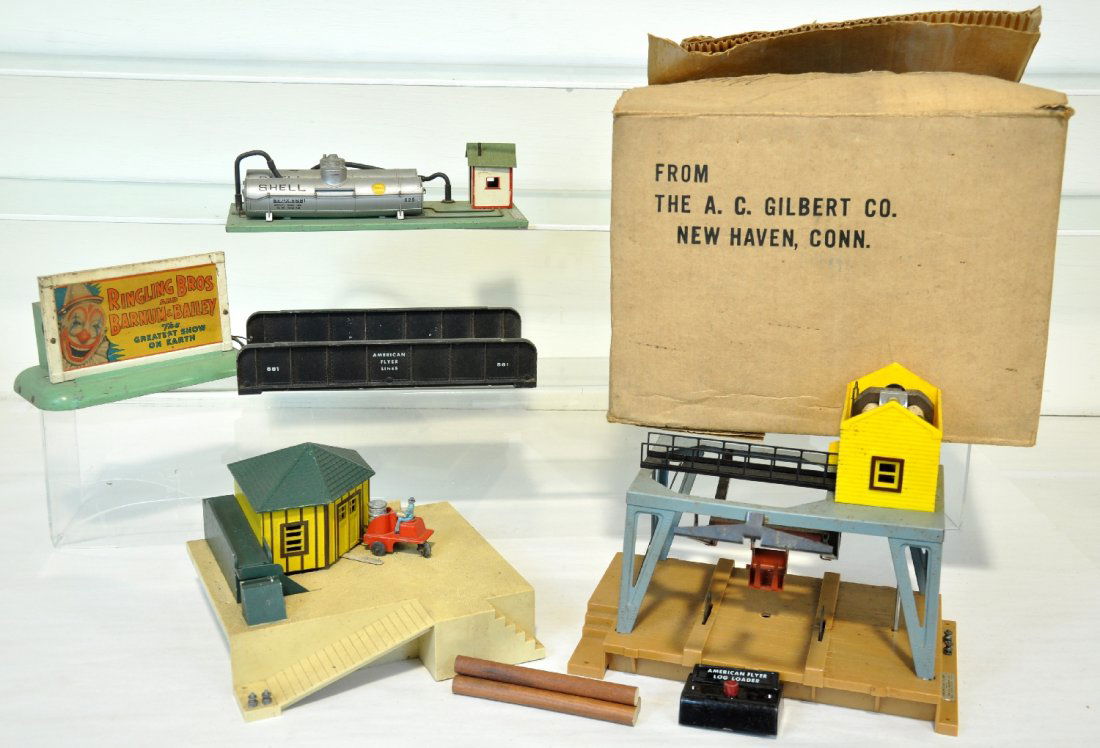5 American Flyer Accessories: Includes a boxed 787 log loader, missing figure & roof; 779 oil drum loader, missing cart's steering wheel & controller; 768 Shell oil supply depot; 581 girder bridge, ob bottom; 577 Ringling Bros whi