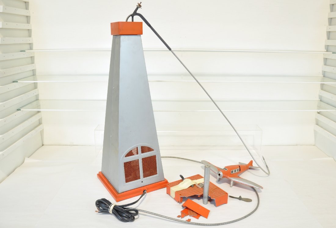 Lionel 55 Airplane: Circa 1936. Includes a clean pylon with nice cast base, has new cord, needs plug; original airplane with replaced prop; controller is fatigued with 1 original handle. Well worth completing. What is he