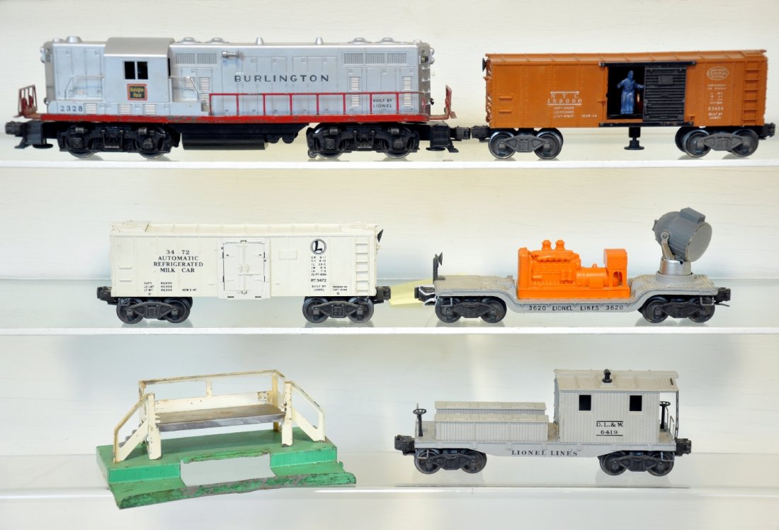 5Pc Lionel 2328 Diesel Freight Set: Includes a 2328 Burlington GP 7 diesel, nice lettering with clean battery box; 3472 milk car & platform; 3620 searchlight car; 3464 NYC operating boxcar; 6419 work caboose. All show moderate playwear,