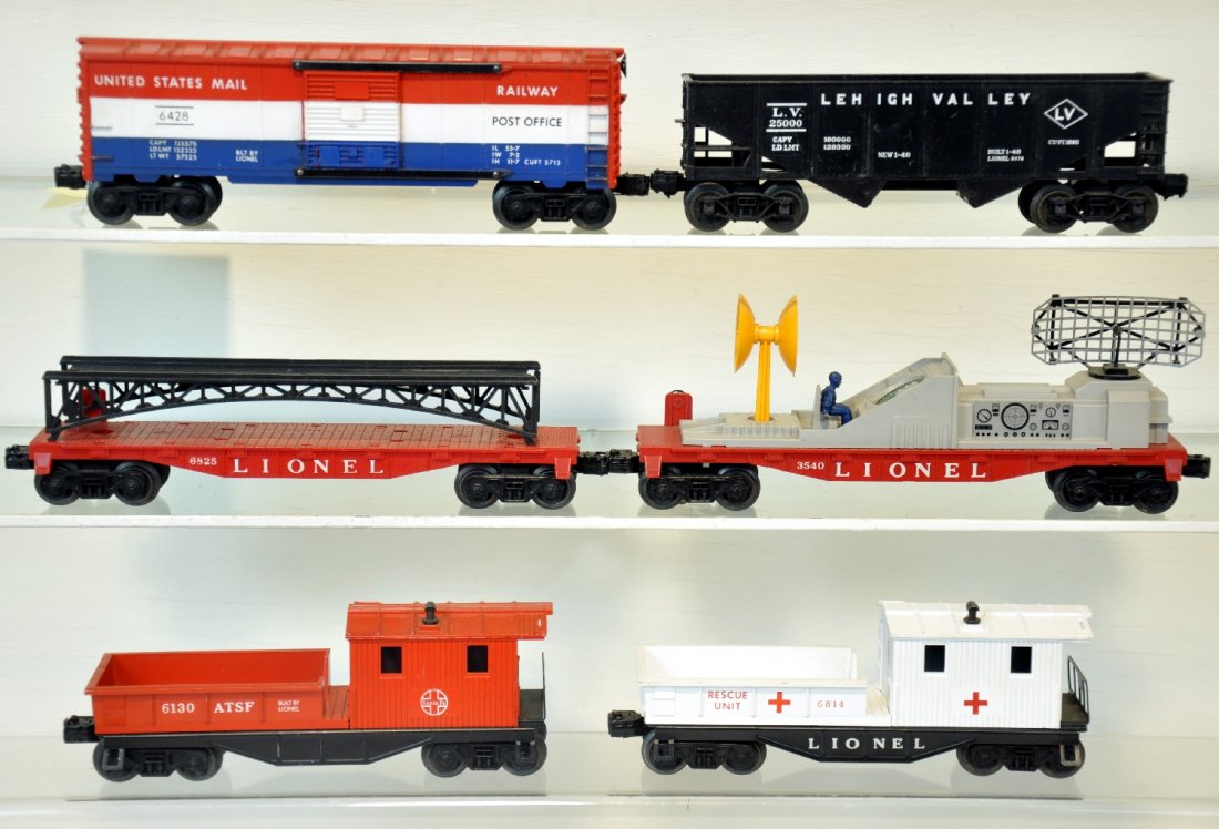 6 Late Lionel Freight Cars: Includes a 3540 radar car, man glued; 6825 flat with black bridge; JC Penney 6814 rescue caboose with black frame; 6468 mail boxcar; 6076 hopper; 6130 SF work caboose. All show light to moderate playw