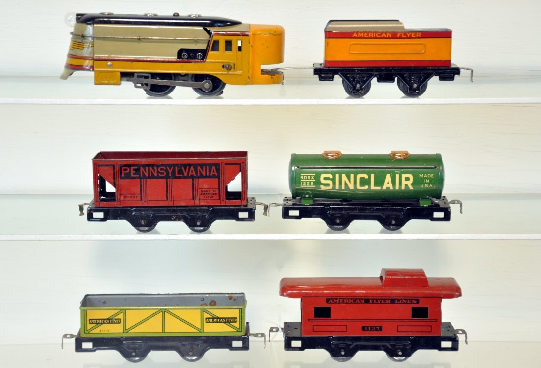 6Pc American Flyer Hiawatha Freight Set: Includes a baby Hiawatha loco, electric, with matching tender; 1257 PR hopper; 1228 Sinclair tank car; 1131 sand car; 1127 caboose. All should polish nicely, showing moderate playwear with track & tra