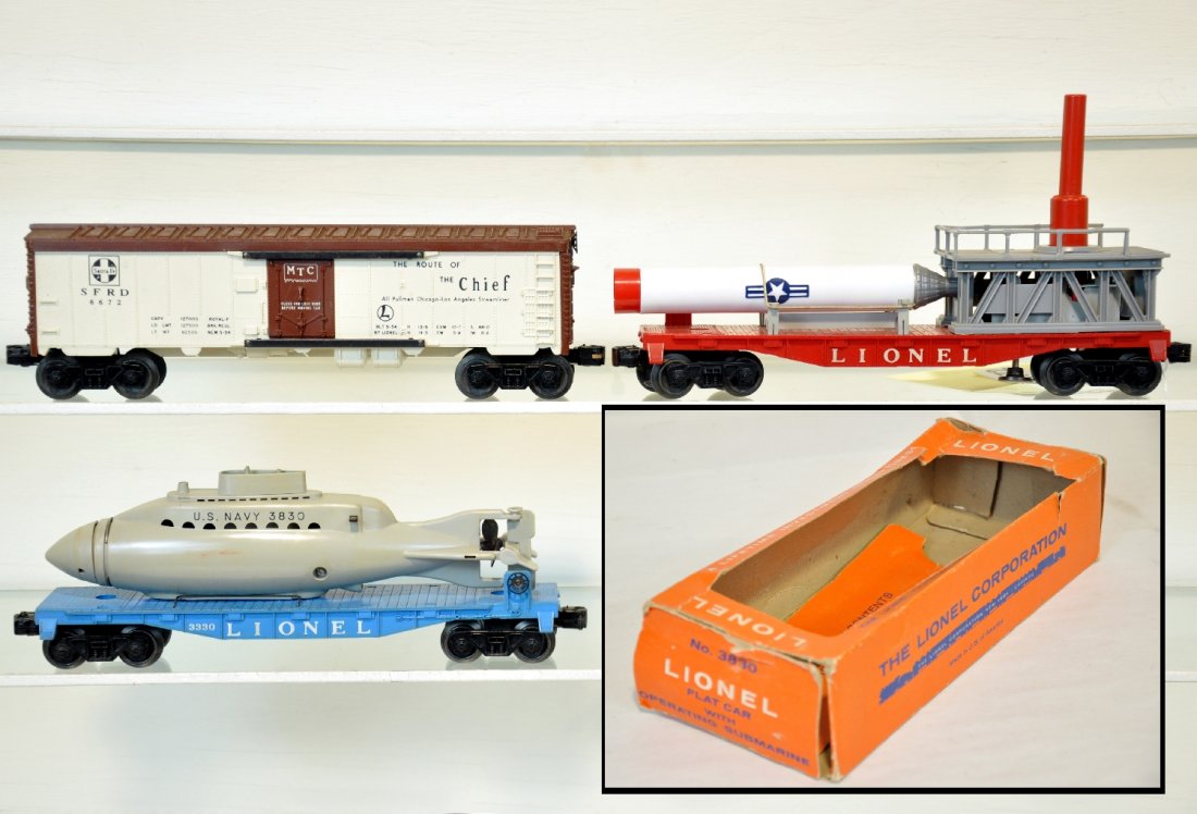 3 Lionel Freight Cars: Includes a boxed 3830 flat with Submarine; 3513 Mercury capsule launching car, broken hand railings, C4; 6672 SF reefer, black lettering, late trucks atached. All are otherwise clean, showing light to