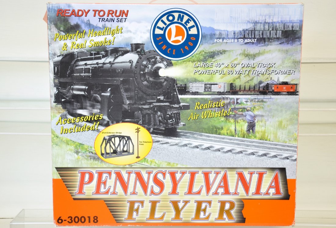 Boxed Lionel PRR Flyer Set 130018: Includes a cast 4-4-2 loco with light & smoke; PRR tender with whistle; boxcar; bulkhead flat & caboose; FastTrack & C80 transformer. All show light playwear with setbox, C8+-9