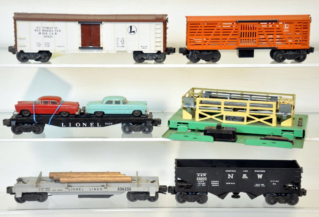 5 Lionel Freight Cars: Includes a 3661 Milk car, car only with cans inside; 3361 log dump car; 6424 auto-loader; 3656 cattle car with pen, no accessories; 3456 N&W operating hopper. All show light to moderate playwear, C6-7