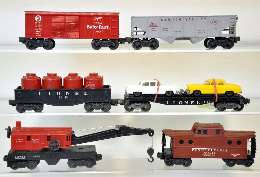 6 Lionel Freight Cars: Includes a 6424 auto-Loader; 6417 PRR N5c Caboose, replaced railings; 6456-25 LV hopper, C6-, top edge chipped; 6560 crane; 6014 BR boxcar; 6112 gondola with canisters. Otherwise, all show light to mo