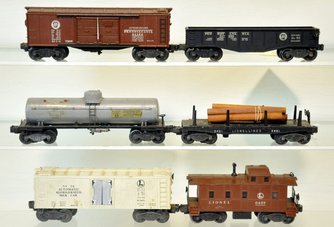 6 Lionel Freight Cars: Includes a gray 2855 Sunoco tank car, 1 decal is 50%, other 90%; 6457 caboose; 3472 milk car, car only; 3461 log dump; 2458 PRR boxcar; 2452 PRR gondola. All show moderate playwear, C6