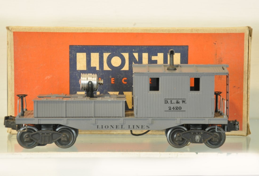 Super Boxed Lionel 2420 Work Caboose: Nice early searchlight work caboose. It has great patina and nice lettering. The box has some damage one side but has its insert. It shows very light playwear, C8+