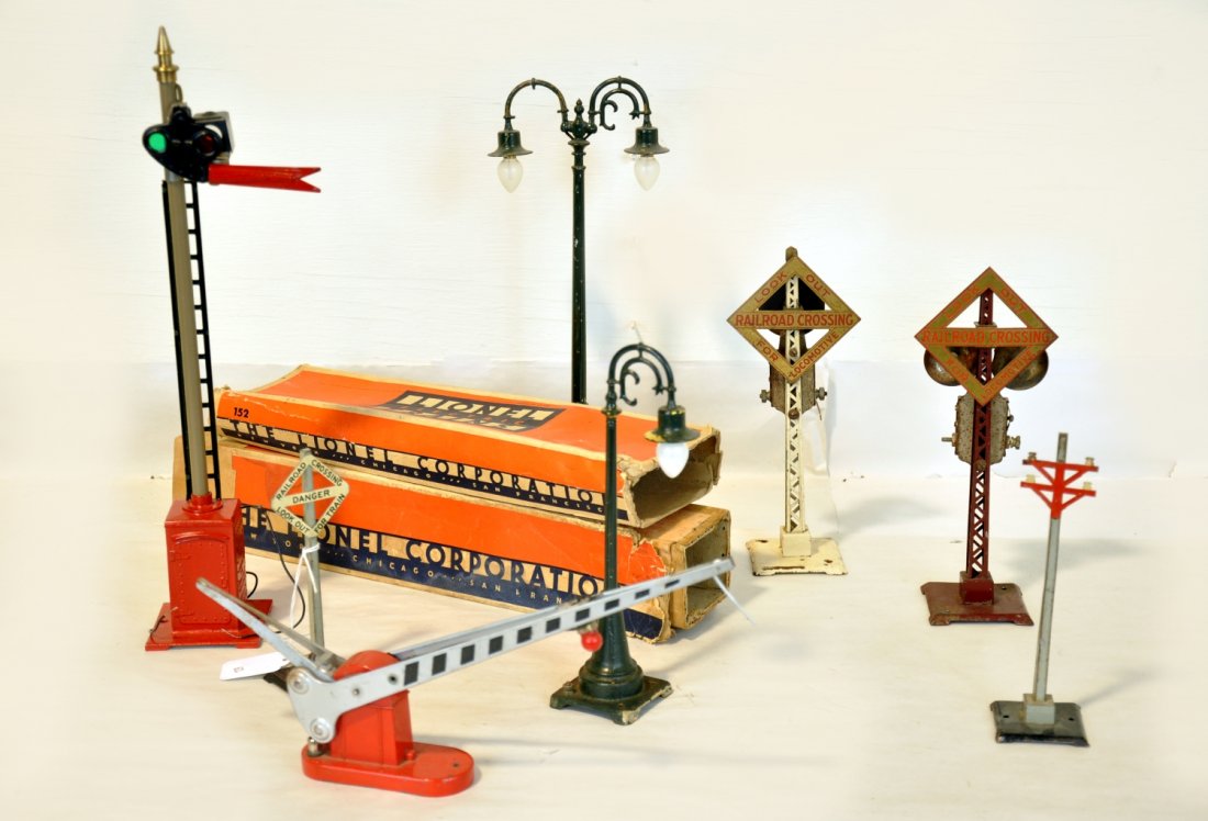 7 Lionel Accessories: Includes a 152 crossing gate, rough box; 63 double lamppost, missing 1 filigree insert; 80N semaphore, replaced base, rough ob with insert; 2 #69 bell signals, 1 has AF single bell mechanism; 59 lampp