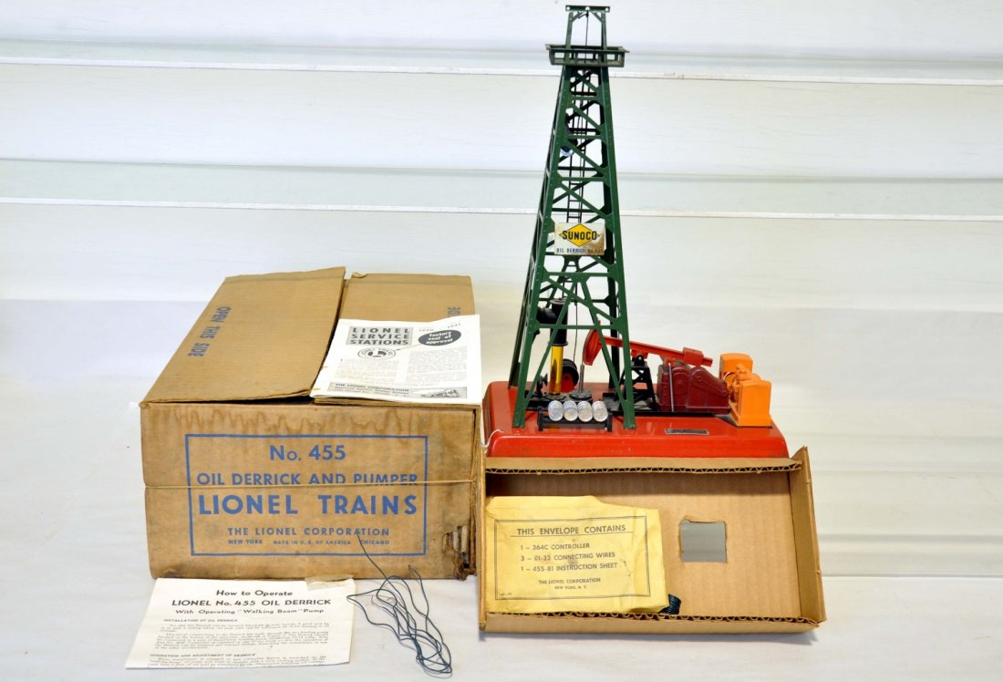 Boxed Lionel 455 Oil Derrick: Clean and complete with drums, sign with some rust, instructions, packet worn with box & insert. It shows moderate playwear, C6