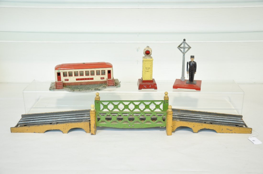 4 Lionel Accessories: Includes a 442 diner, missing shrubs; 89 crossing flasher; 1045 flagman, silver redone; 106 3 piece bridge, 1 replaced finial. All show moderate playwear, C4-5