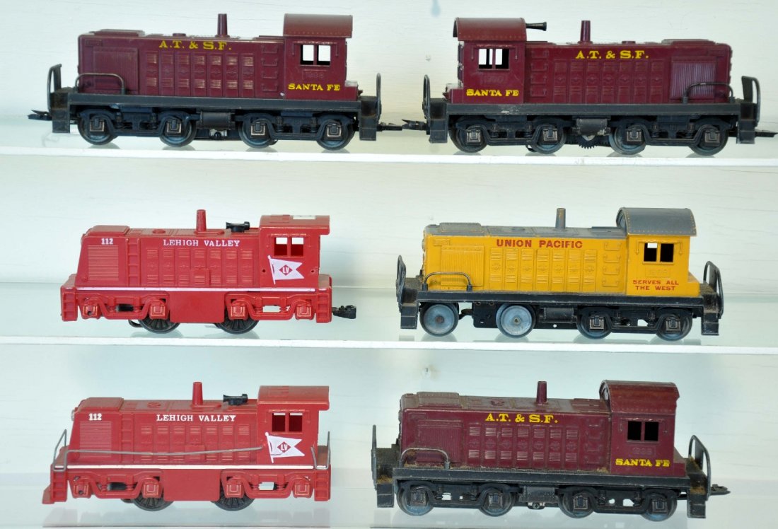 6 Marx Diesel Locomotives: Includes 3 #1998 AT&SF switchers, 1 has forward facing cab windows; 1998 UP switcher Dummy unit, missing side frames 1 end; 2 LV switchers, 1 has broken coupler. All otherwise show moderate playwear