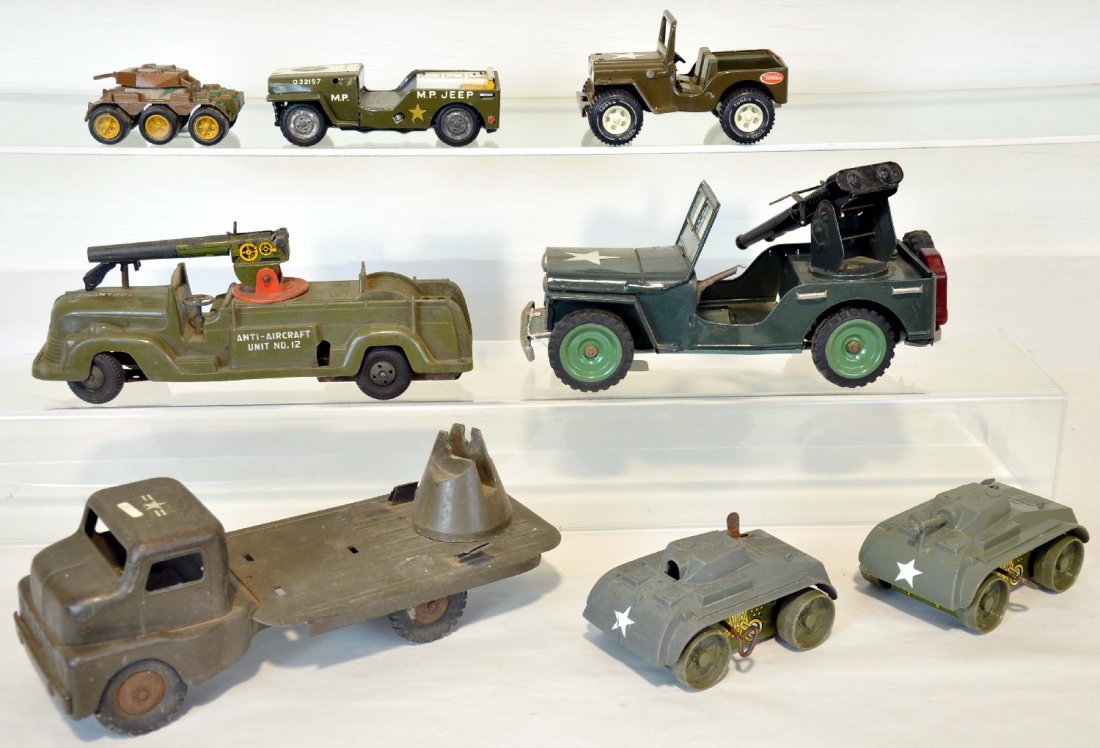 8 Vintage Military Toys: Largest is 12 inches long. Includes Japanese anti aircraft jeep; Marx anti aircraft unit #12, 1 broken ladder support missing machine gun, and 5 other assorted pieces incomplete. All sold as is. View 