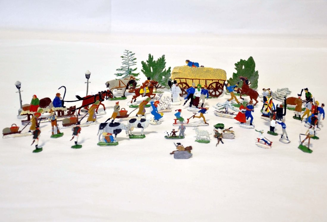 Large Group of Vintage Snow Scene Flats: Circa 1940s. Includes 35+ hand painted lead figures and scenery that make up a charming village snow scene. They were taken care of and show light to moderate playwear, C7-7+ overall