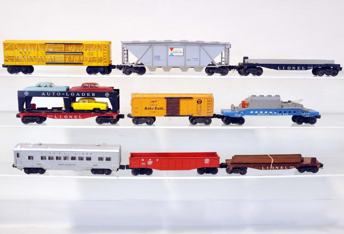 9 Lionel Freight Cars: Includes a 6346 Alcoa hopper, melt mark on 1 side; 6262 wheel flat; 6544 missile launching car, broken; 2421 Maplewood Pullman; 6414 auto-loader, 3 cars only are incomplete; 2454 boxcar; 6511 flat; 64