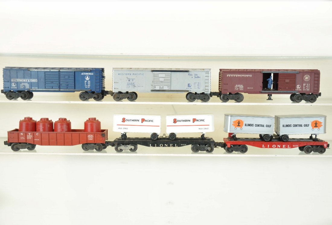6 Lionel Freight Cars: Includes a 3484 operating PRR boxcar; 6468 B&O boxcar; 6464-1 WP boxcar; 6462 brick red gondola with canisters; 6430 & 6424 flats with modern era trailers. All show moderate playwear, C5-7