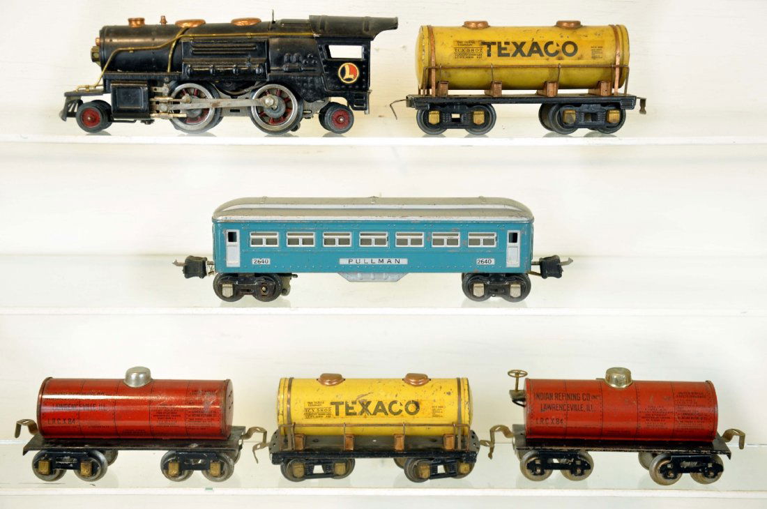 6 Pre War Toy Trains: Includes a Lionel 259E loco; 2460 Pullman; 2 American Flyer Texaco tank cars; 2 Dorfan tank cars, 1 missing brake wheel assembly. They show moderate playwear, otherwise C5+-6