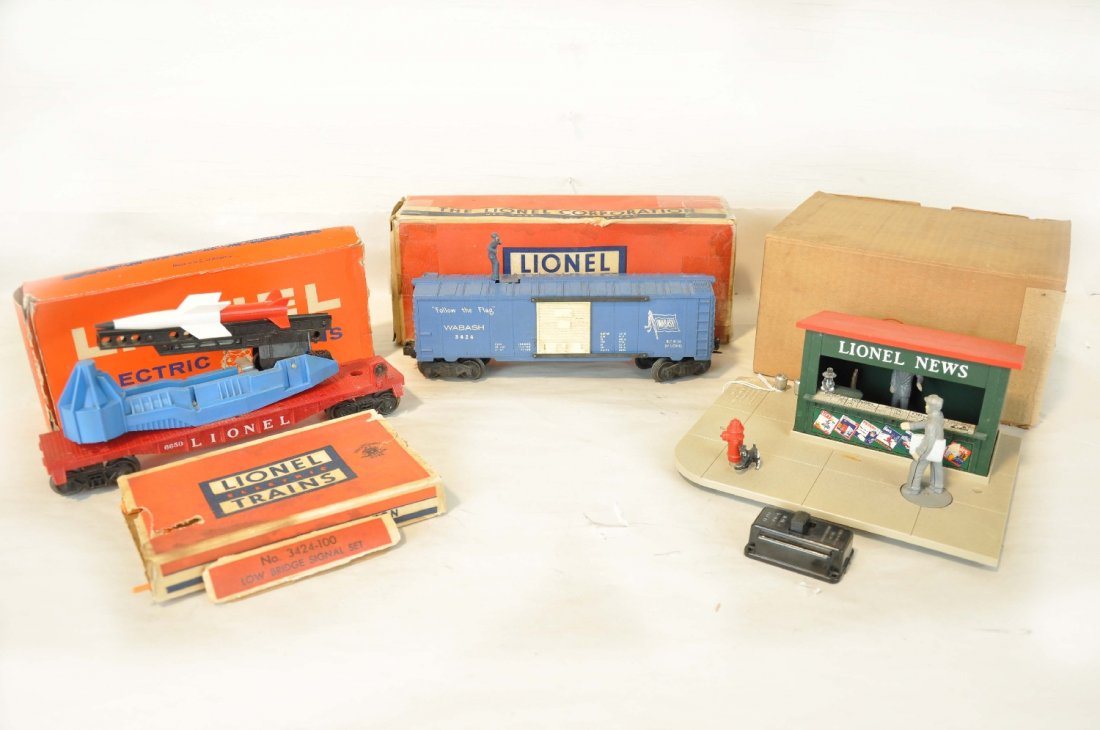 3 Boxed Lionel Trains: Includes a 128 animated newsstand, no paper, small dent near terminals on plastic; 6650 ICBM launcher, rough ob; 3424 brakeman car with -100 telltale set, rough boxes. All show moderate playwear, othe