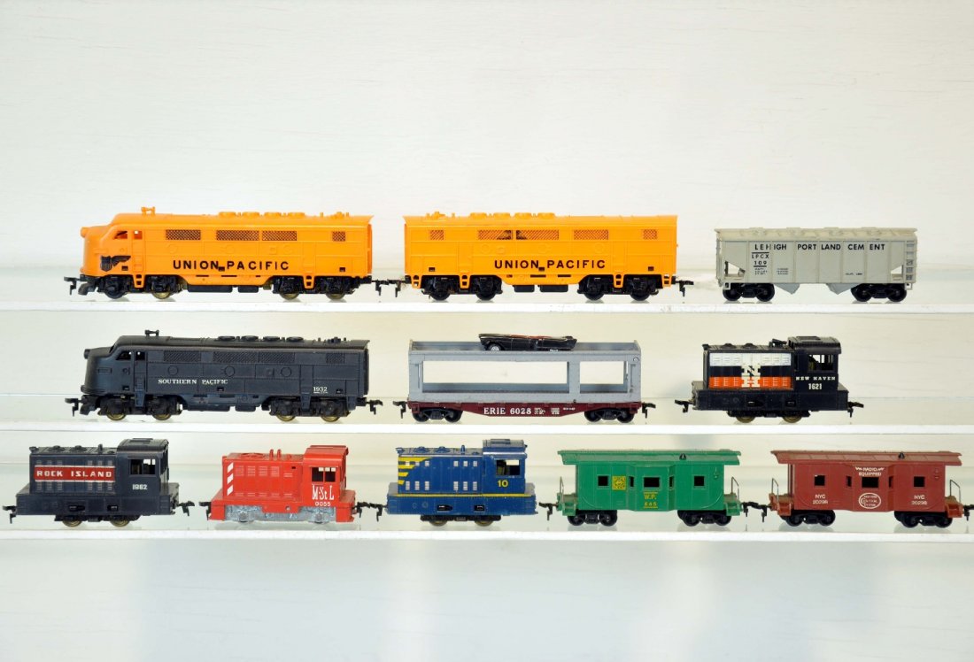 11Pc Marx HO lot: Includes UP F7 AB Diesels, one broken step; New Haven Rock Island; blue #10 Switchers, Repainted SP Diesel; 4 Freight Cars; plus a Lionel Double O 55 M&StL Diesel. All show light to moderate playwear 