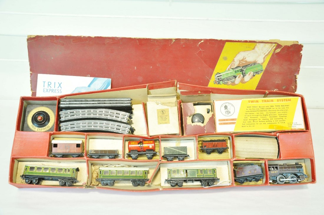 Boxed Partial Trix HO Twin Train Set: Scarce set. Includes a 5647 LMS 0-4-0 loco & tender; 21/159 baggage car with 2 matching coaches; (missing second loco); 5 small freight wagons with transformer, extra controller, track & instructions.