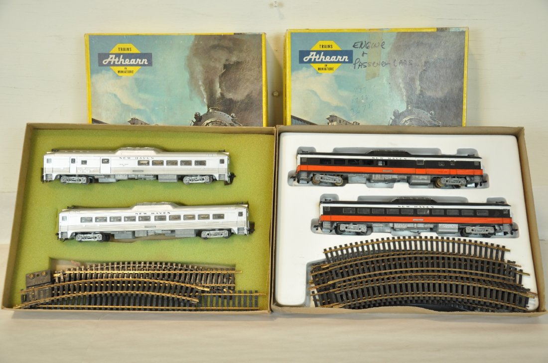 2 Boxed Athearn HO NH Budd Sets: Includes the McGuiness colors set and a silver set, both with powered unit with trail car. They include track and display set boxes, 1 has foam, C8