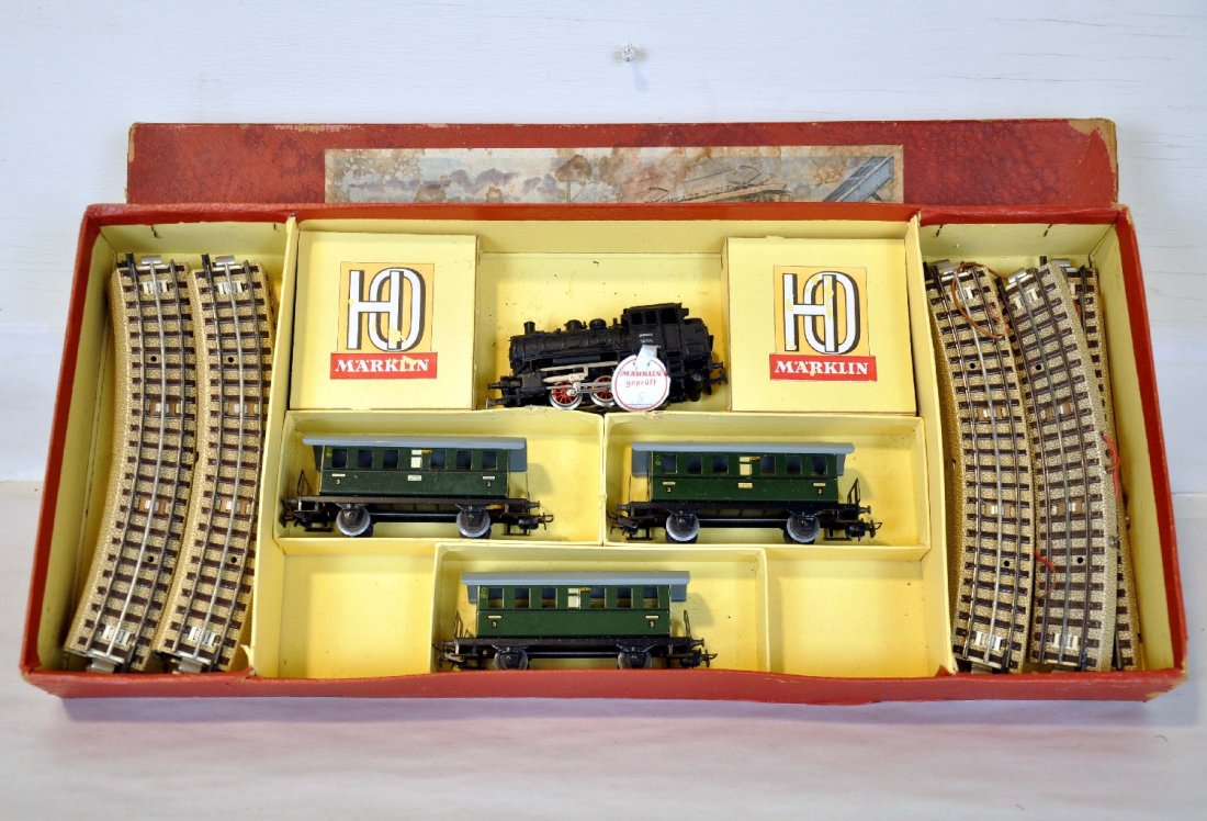 Early Boxed Marklin HO Set CM 827/3: Includes a CM 800 steam loco with 3 3rd class coaches, early 3-rail track and display setbox with inserts. It shows light playwear, C8