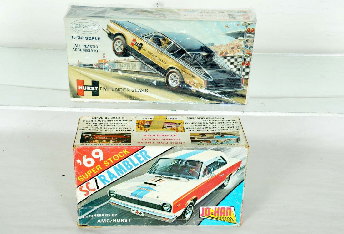 2 Scarce Vintage Model Kits: Includes a 1967 Aurora 1/32 Hurst Hemi Under Glass Plymouth Barracuda; Jo-Han GC-2500 1969 SC/Rambler Super stock. Both are unbuilt with parts on spru and instructions. Probably 1/25, but not marked.