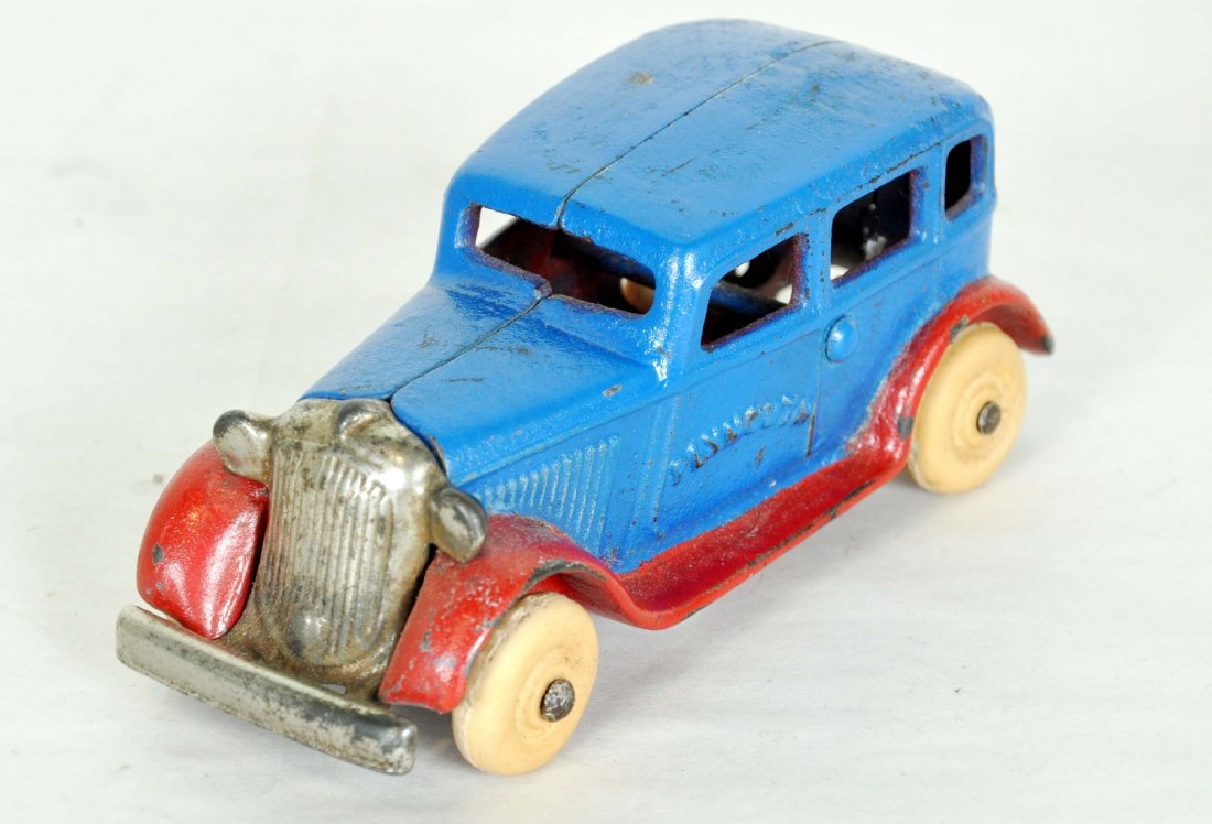 Scarce Arcade 2-Tone Plymouth Sedan: 4 1/2" painted cast iron with nickel grill and white rubber tires. It is clean with bright finish. 1 tire has been repaired, but doesn't detract from this super example, C7