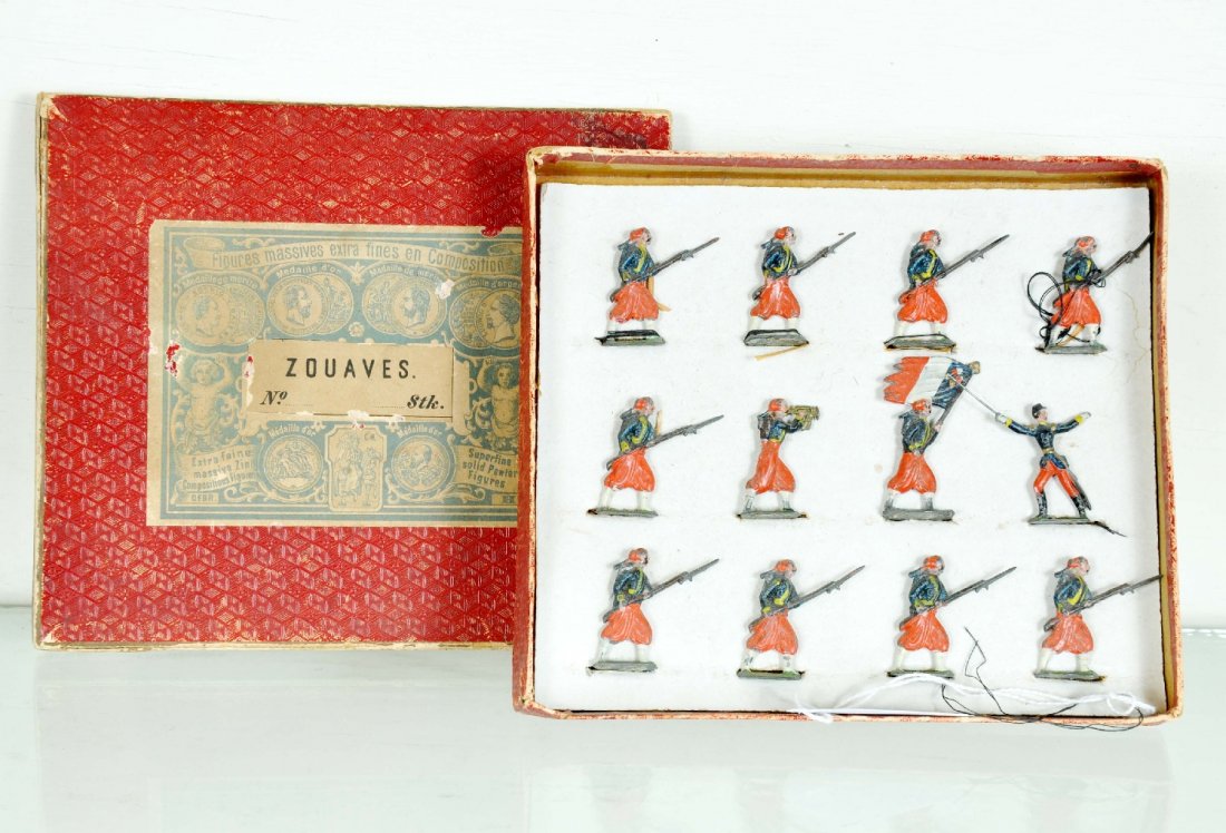Boxed Heyde Zouaves: Early set Circa 1900. 1 3/8" figures with bugler, officer; flag bearer and 9 advancing soldiers. They are fairly clean with no zinc pest. They show light playwear with an original box with insert, top